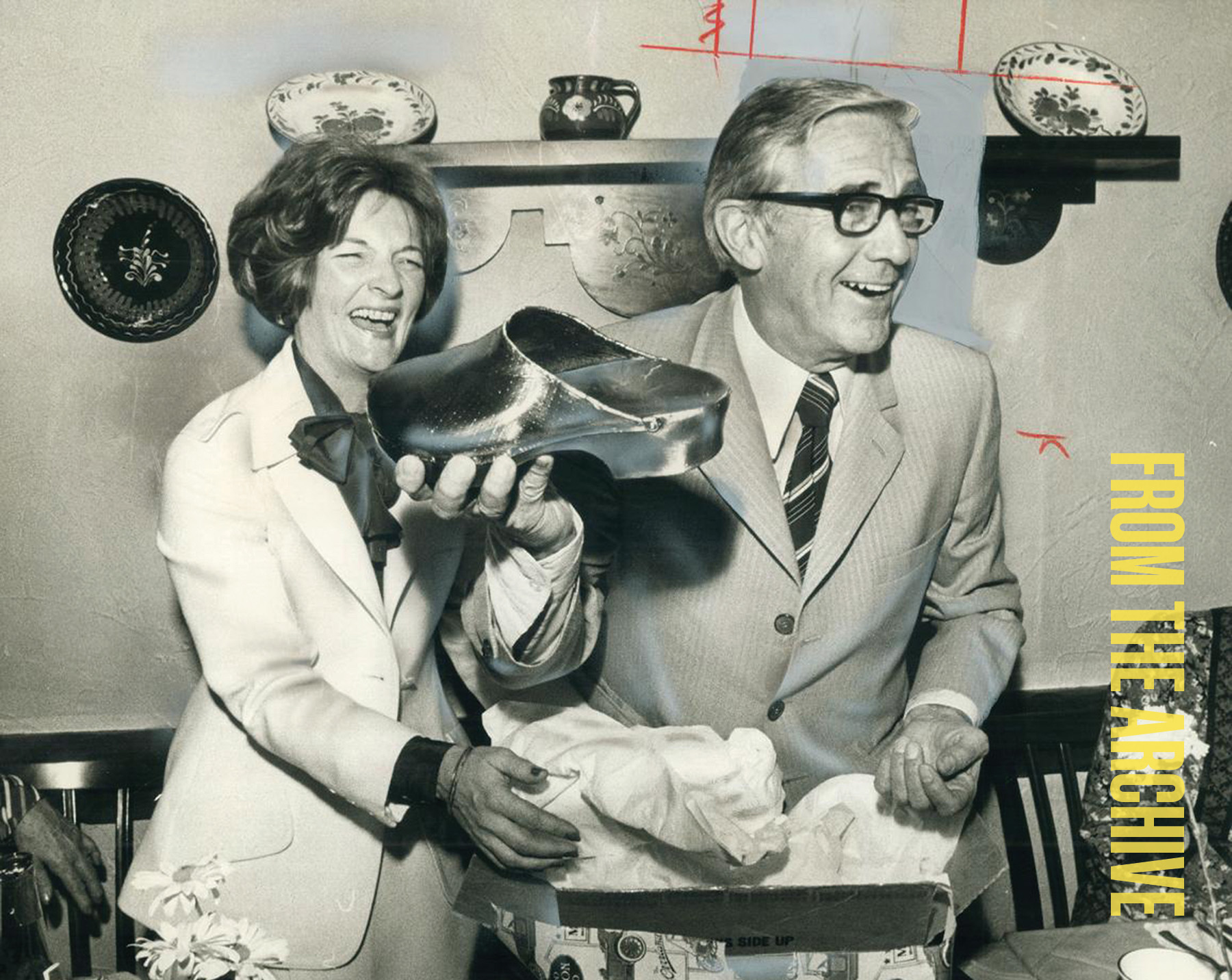 Photo of Dr Bigelow at his retirement party, being gifted his bronzed surgery clogs.